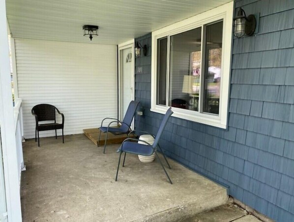 A porch with two chairs, a window, and a door. - Comfortable, newly renovated home, walk to beach!
(Michigan City)