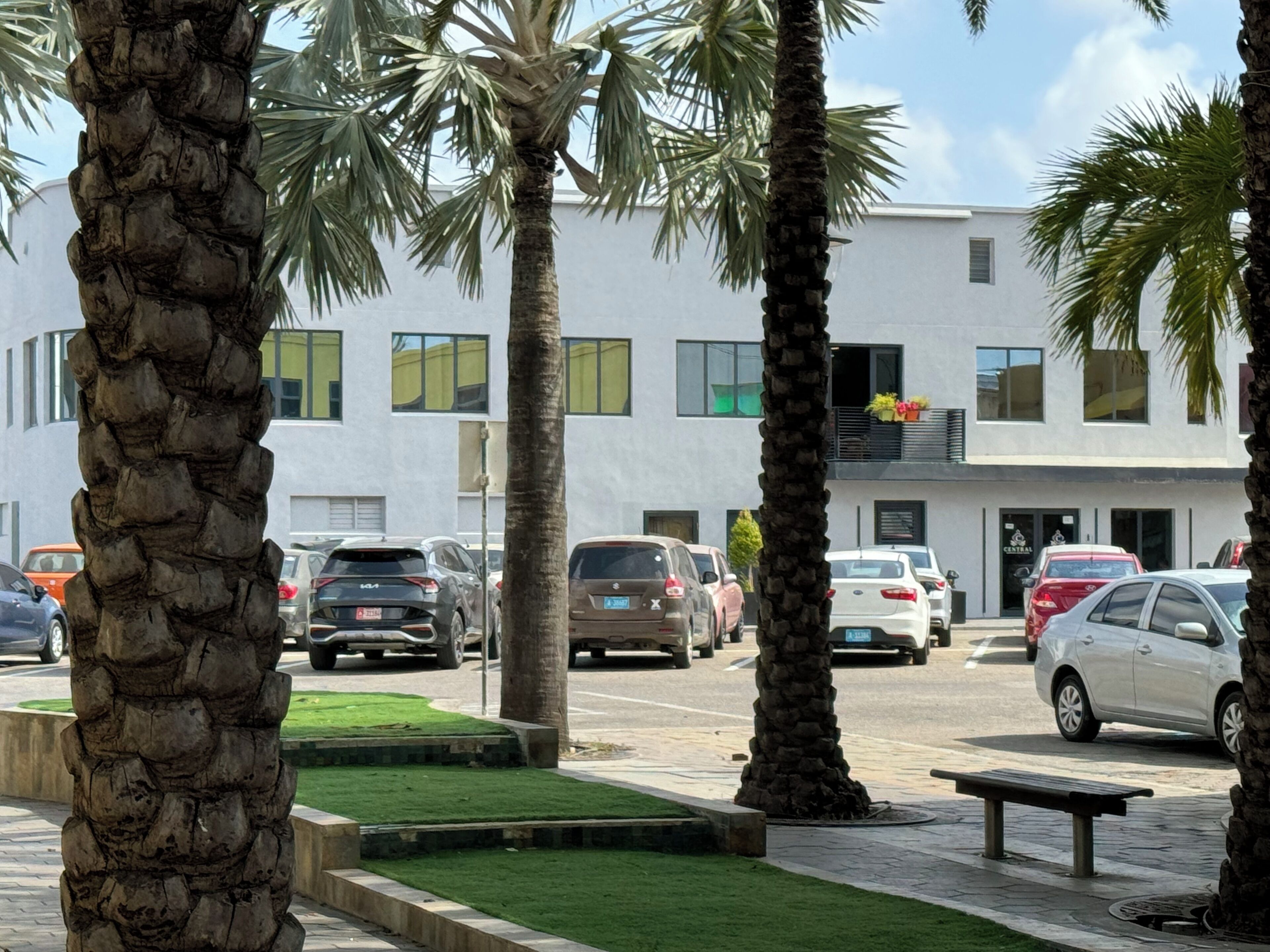 A modern building with a flat facade, multiple windows, and a visible entrance.