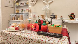 A dining table with various food items, condiments, and a remote control. - Friends Hotel (Blackpool)