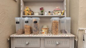 A kitchen counter with storage containers labeled "Corn Flakes" and "Cereal." - Friends Hotel (Blackpool)