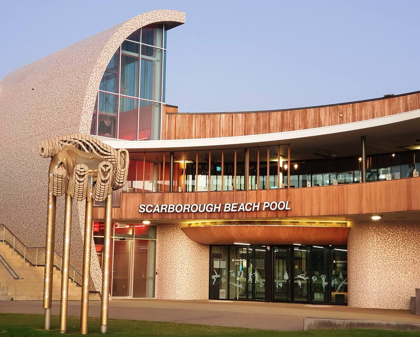 A modern building with a sign reading "Scarborough Beach Pool".