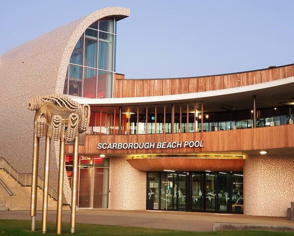 A modern building with a sign reading "Scarborough Beach Pool".