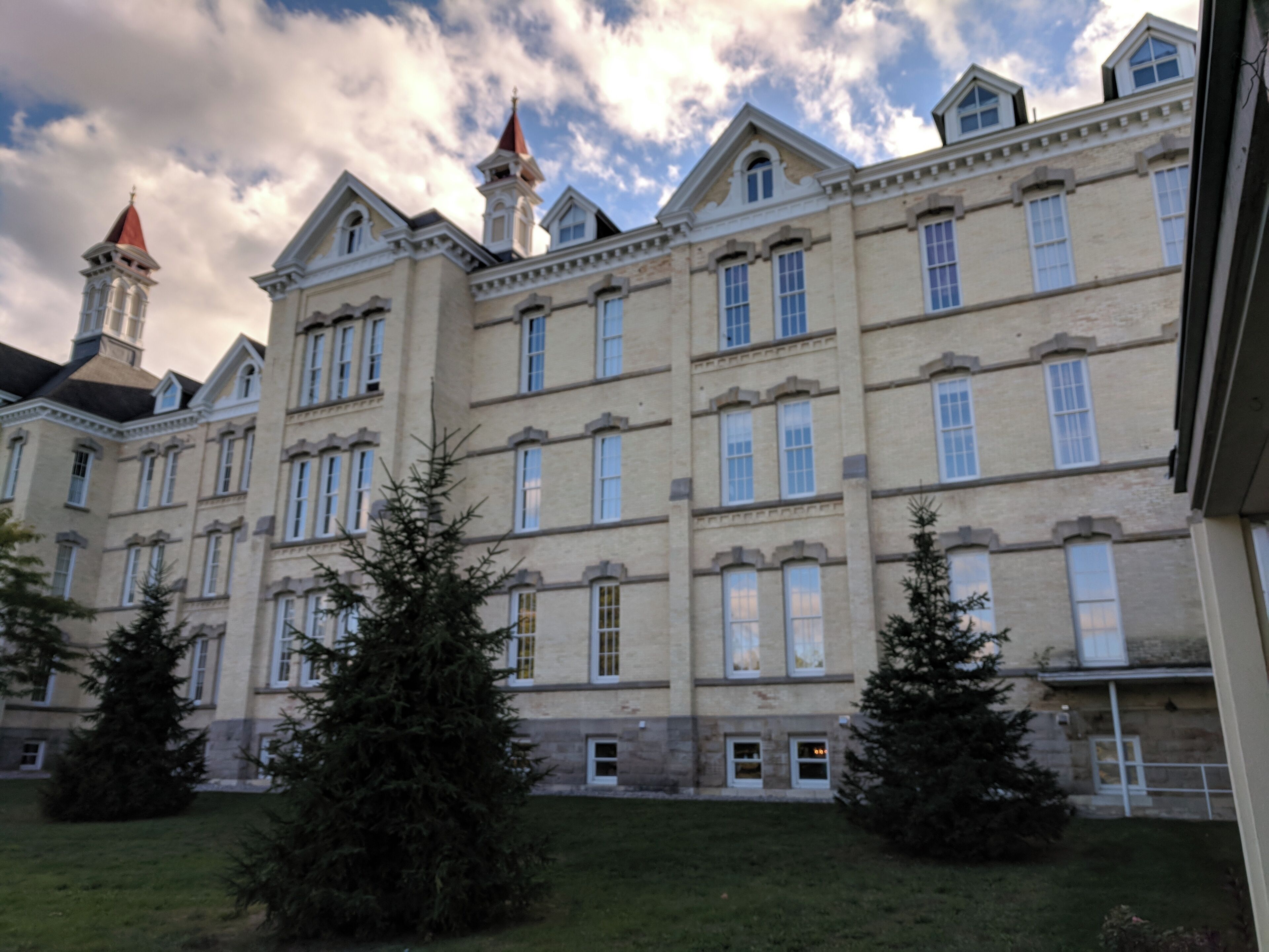 A large, historic building with multiple windows and a prominent tower.