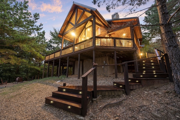 Warm, inviting lights mingled with rustic wooded charm beckon you to enter this luxury cabin—ideal for a romantic weekend, a family retreat, or a friend getaway.