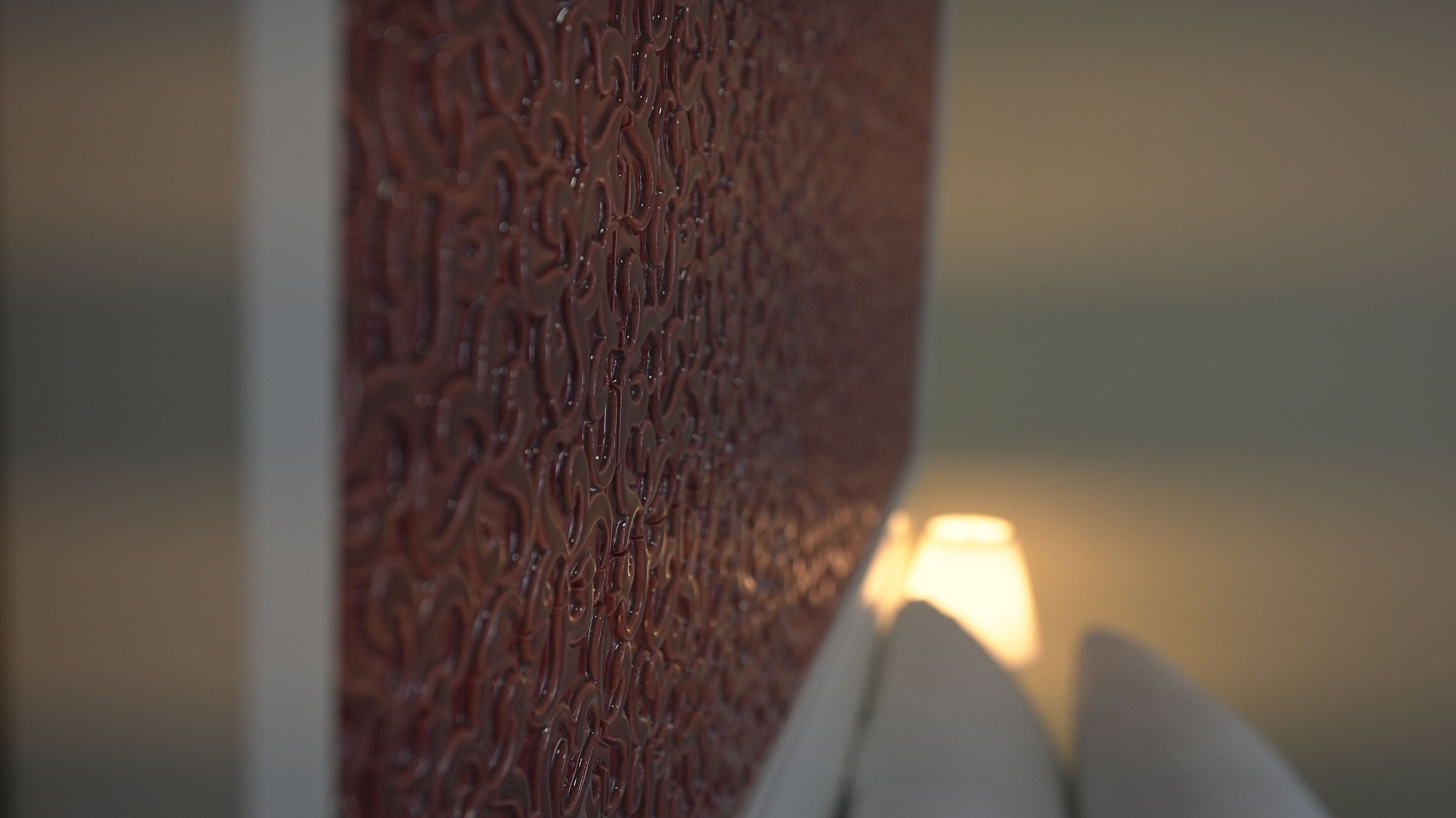 A close-up of a textured wall with a patterned design.