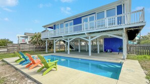 A two-story house with a pool and outdoor seating area. - WATERFRONT, PRIVATE POOL, GREAT FOR FAMILES & DOG FRIENDLY! (Gulf Shores)