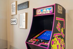 A vintage arcade machine with a pink and black color scheme, featuring the Pac-Man logo. - New Log Cabin with Private Hot Tub, Free Daily Activities, Arcade & Shuffleboard (Branson)