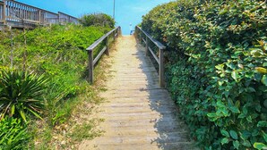 A wooden pathway leading uphill, flanked by dense greenery and a wooden fence on one side. - Sea Vista - Oceanside 6 Bed, 5.2 Bath, Rec Room, Pool, Hot tub! (Duck)