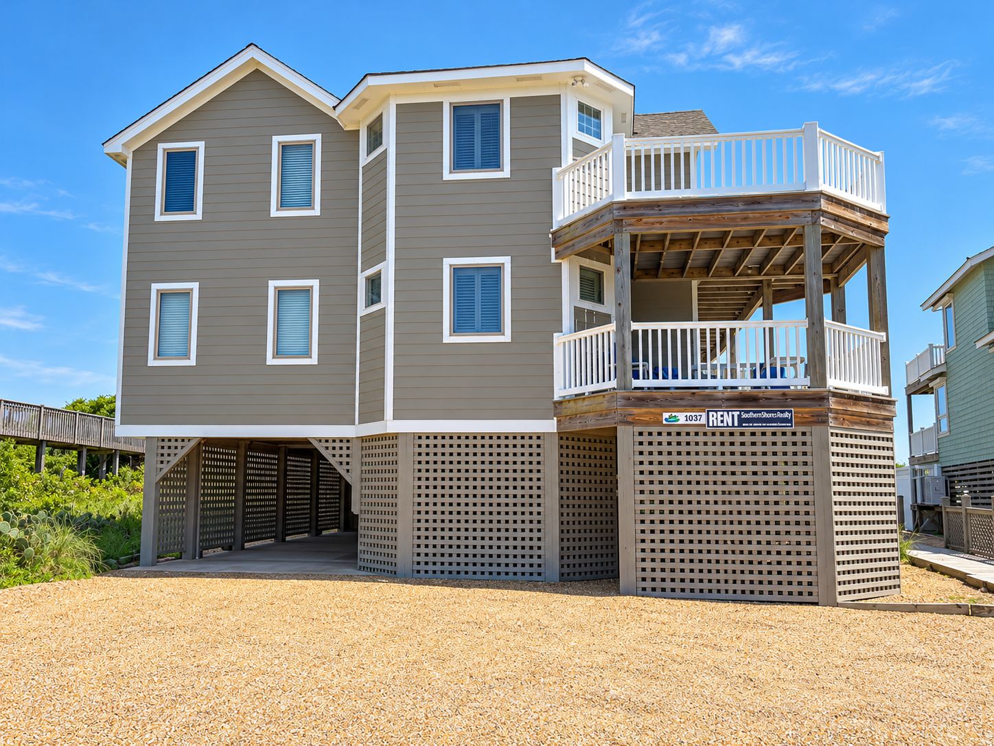 A two-story building with a balcony and a deck area.