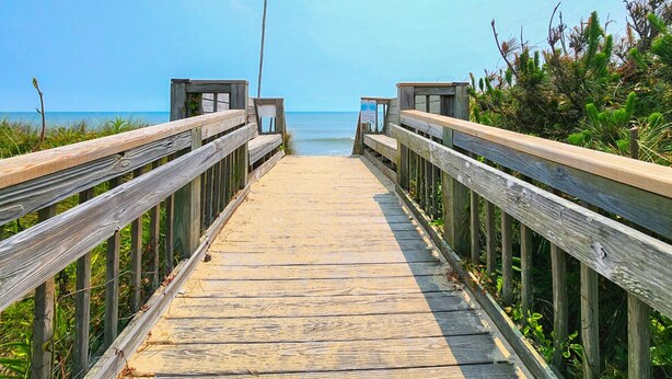 A wooden boardwalk leading to a beach with a clear view of the ocean. - Southern Comfort in Duck! Oceanside in Duck, 6 bed, 6.1 bath, dog friendly with pool and hot tub! (Duck)
