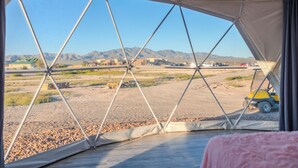 A tented area with a view of a desert landscape and mountains. - Tirrito Farm (Willcox)