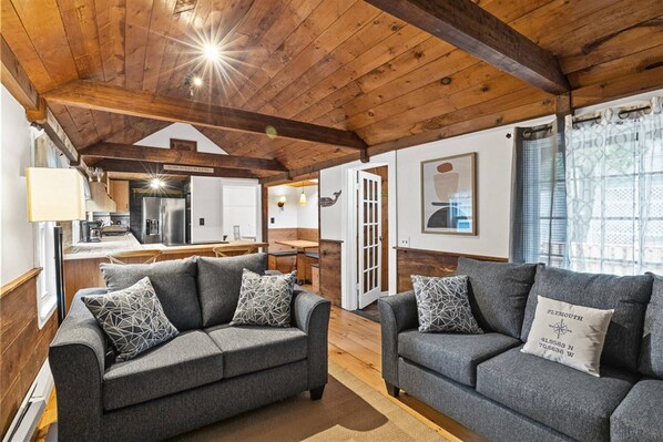 Relax in this inviting space with a modern kitchen, dining area, and comfortable seating.
