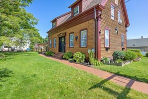 Stroll up the inviting red pathway to this charming home, surrounded by a beautifully manicured lawn and lush garden.