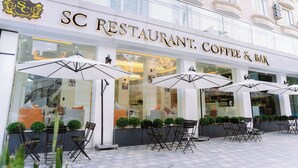 A SC RESTAURANT, COFFEE & BAR with outdoor seating and large umbrellas. - SC Luxury Hotel (Bai Chay)