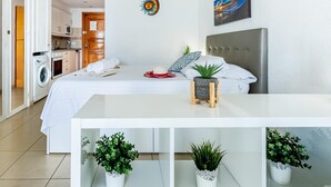 A modern bedroom with a bed, bedside table, and potted plants. - Port Royale shine and bright, heated pool (Los Cristianos)