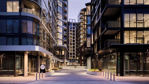 A modern urban building with multiple floors, large windows, and a central staircase. - Abode Phillip (Phillip)