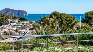 A coastal town with a prominent hill, clear blue sea, and lush greenery. - Villa for rent in Benissa, AZUR. (Benissa)