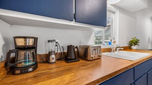 A kitchen with a coffee maker, toaster, blender, and sink. - Beautiful and cozy apartment in Bonita w/Garden  (Bonita Springs)