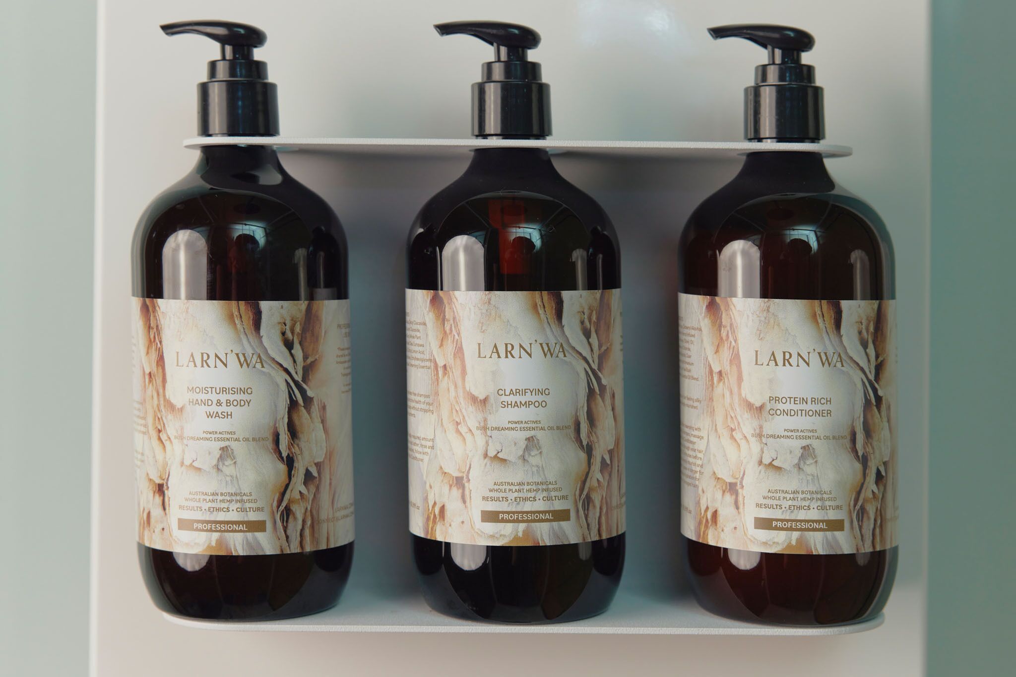 Three bottles of Larn Wa products on a shelf.