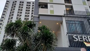 A multi-story building with a modern design, featuring balconies and large windows. - Day Use Inn At Serpong Green View Apartment Bsd (South Tangerang)