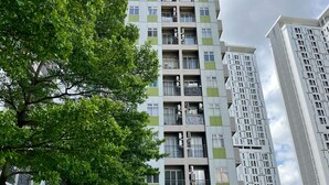 A multi-story residential building with balconies, large windows, and air conditioning units. - Day Use Inn At Serpong Green View Apartment Bsd (South Tangerang)