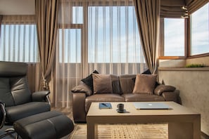 Luxury One-Bedroom Apartment - Corner | Living area | 50-inch Smart TV with cable channels, Netflix, streaming services