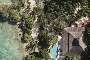 An aerial view of a resort with a swimming pool, palm trees, and a beach. - Eliana Resort And Spa (Rote Island)