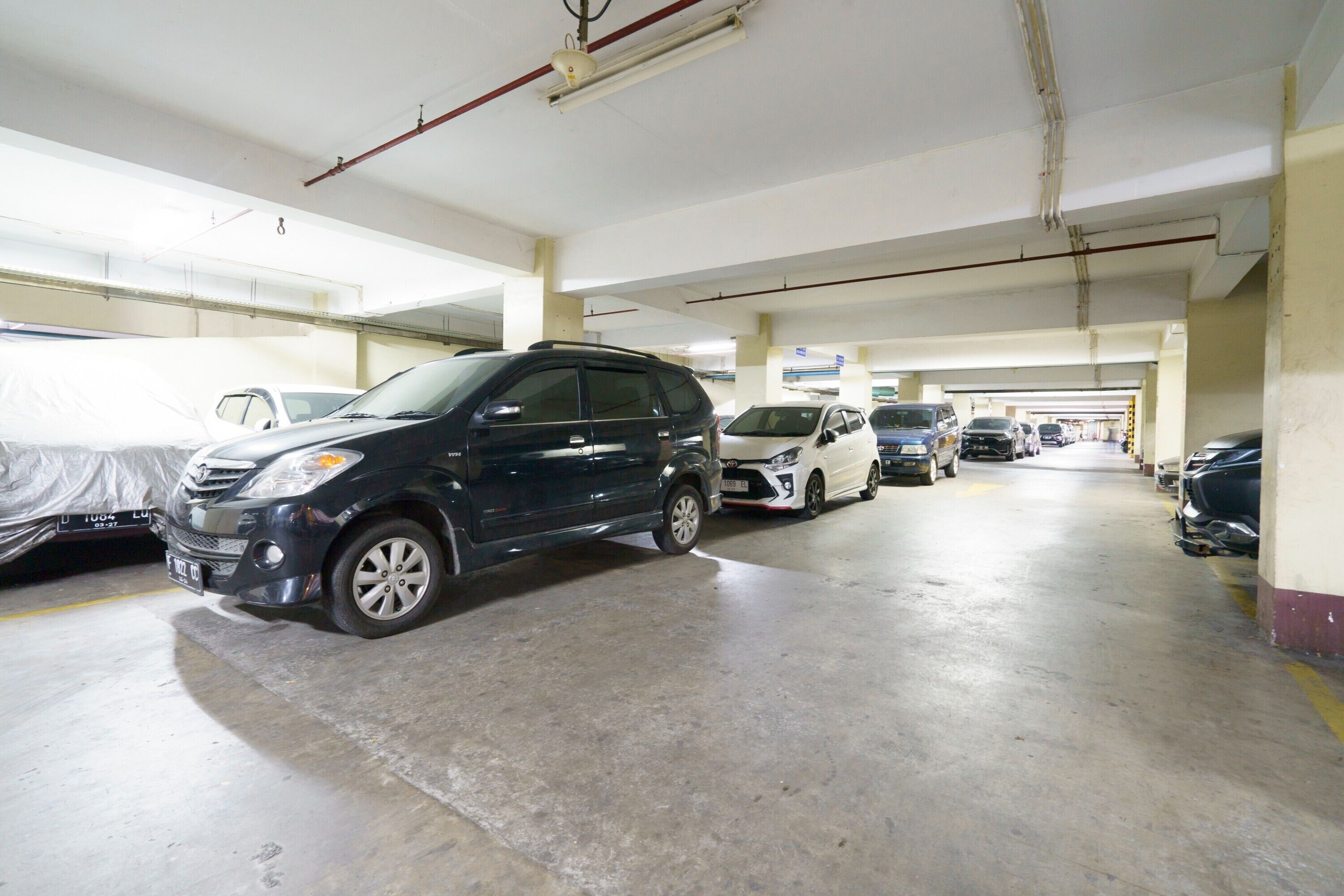 A multi-level parking garage with several cars parked.