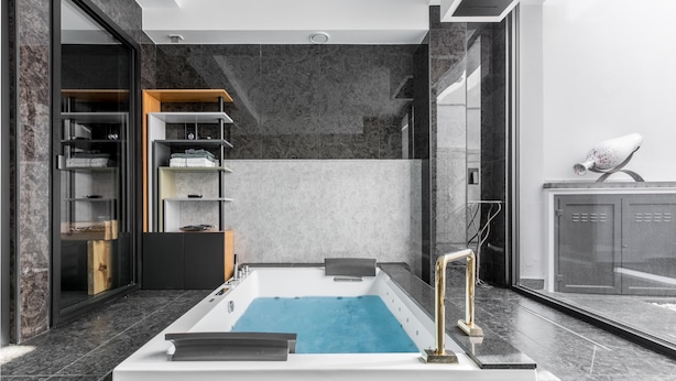 A modern bathroom with a freestanding bathtub, marble flooring, and a glass shower enclosure. - 3737 La Catedral by Barbarhouse (Mesagne)