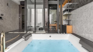 A modern bathroom with a large bathtub, a glass shower enclosure, and a wooden shelf unit. - 3737 La Catedral by Barbarhouse (Mesagne)