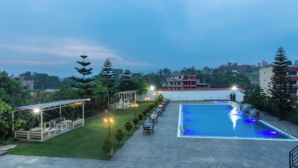 A rooftop pool area with a seating area and a pergola with string lights. - Hotel View Bhaktapur (Suryabinayak)