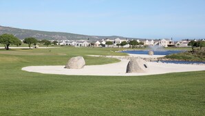 A golf course with bunkers, a water feature, and a backdrop of houses. - Ellefsen Golf Suite 137, Langebaan, 4 - Sleeper (Langebaan)