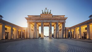 Ein prachtvoller Eingangsbereich mit großen Säulen und einer zentralen Skulptur, vermutlich ein historisches Denkmal.