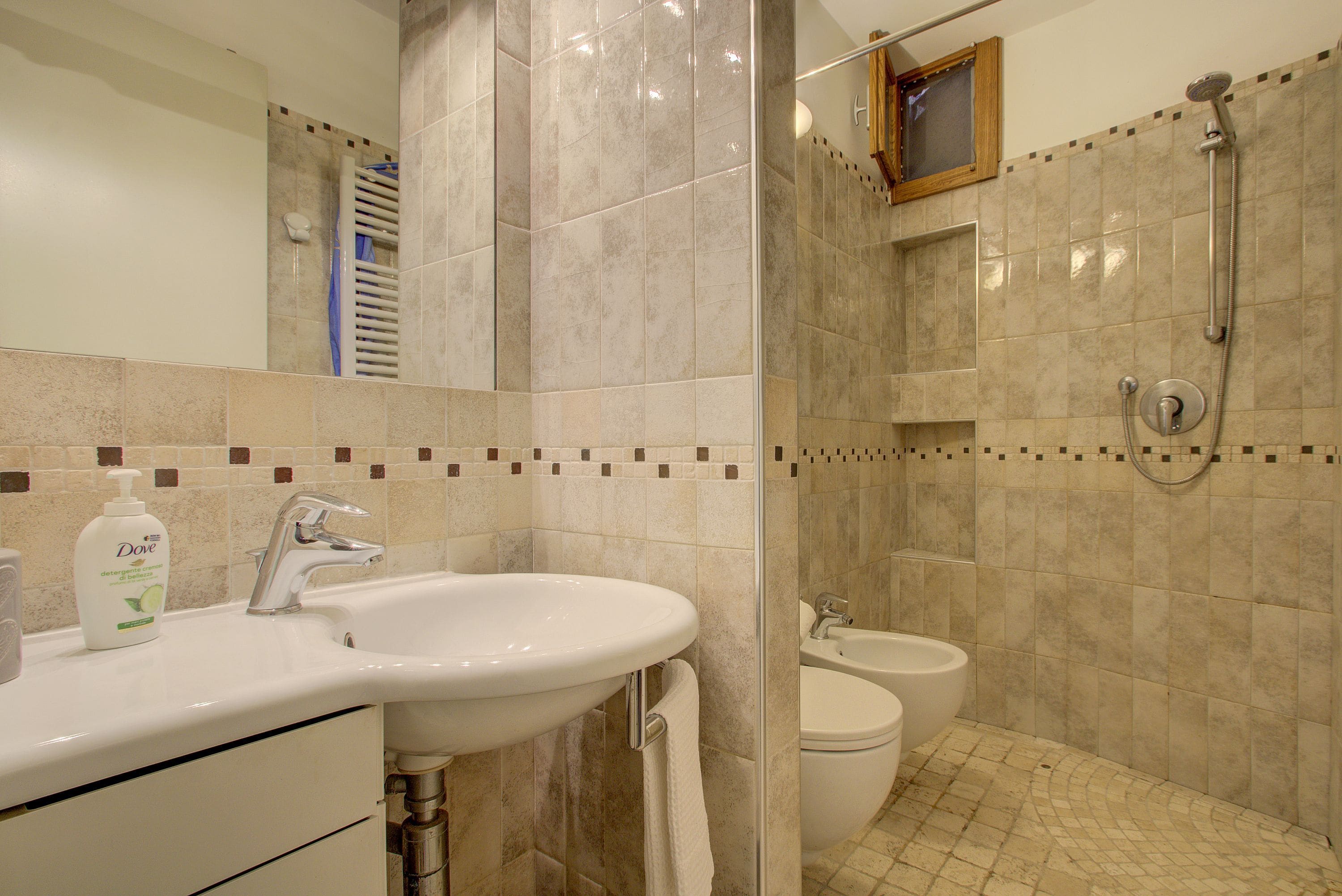 A bathroom with a sink, toilet, and shower.
