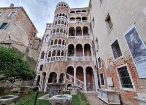 A historic building with multiple balconies and a fountain in the courtyard. - SPIRAL-Canal-View (Venice)