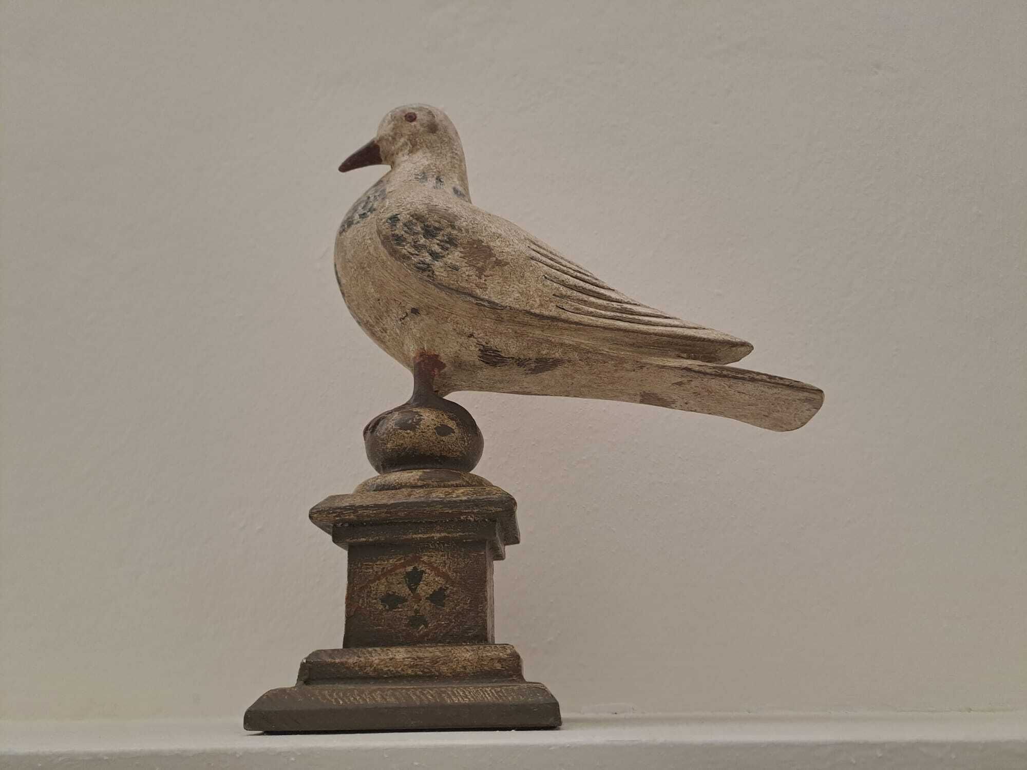 A bird sculpture on a pedestal.