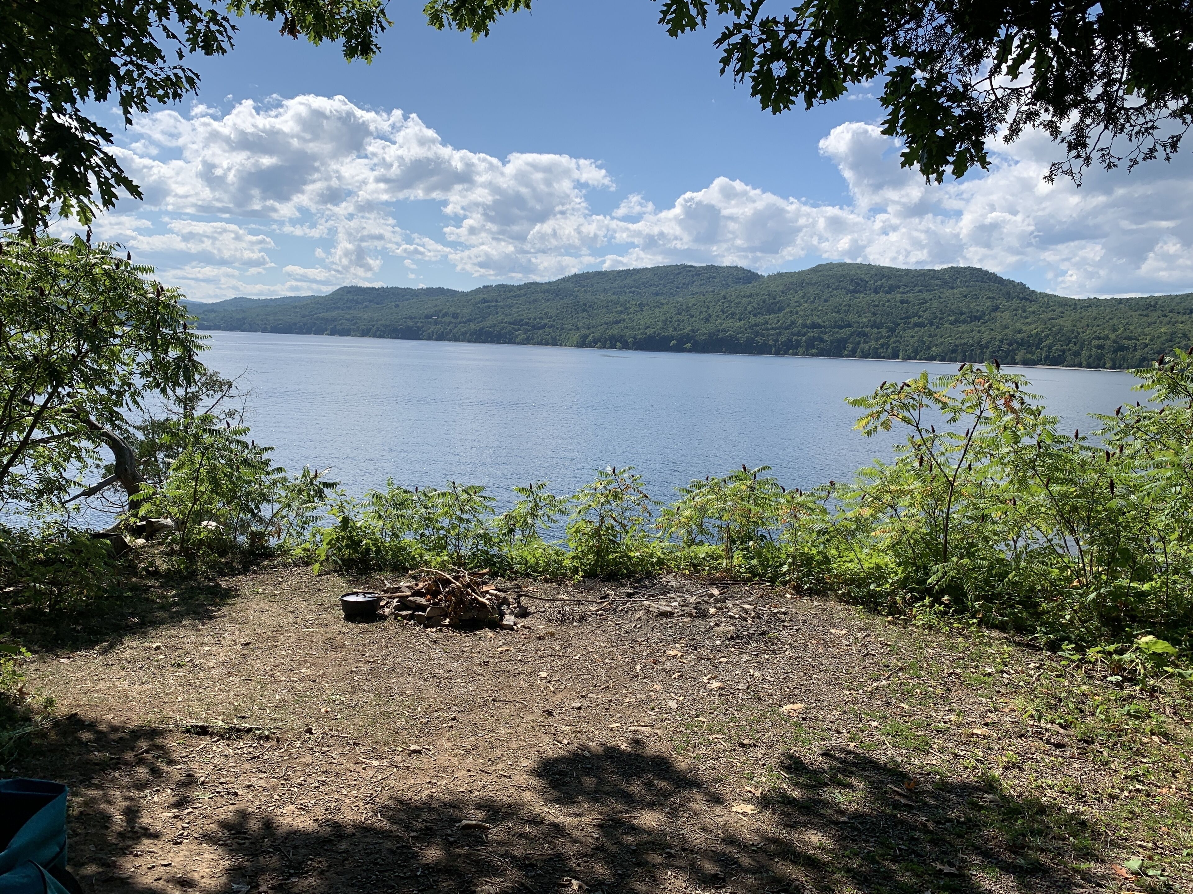 Een camping met uitzicht op een meer en bergen.