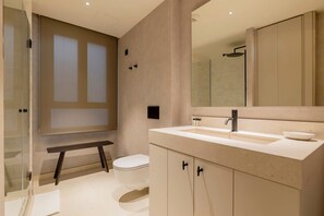A modern bathroom with a large mirror, a sink, and a toilet. - w* | Lovely 1BR at Palacio Real (Madrid)
