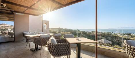 A modern outdoor dining area with a panoramic view of the landscape.