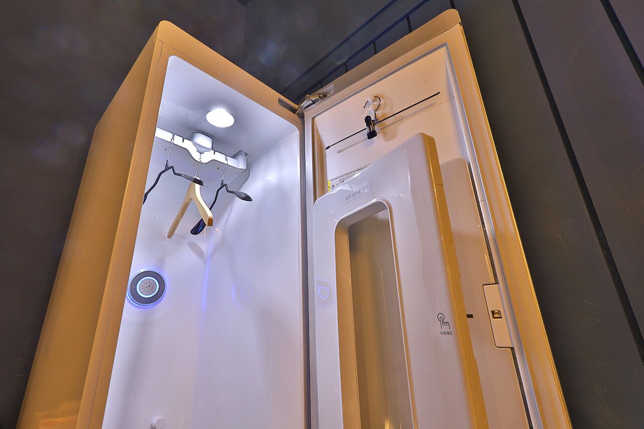 A modern bathroom with a bathtub, shower, and a towel rack.