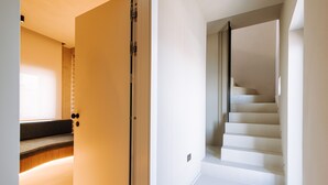 A modern interior with a staircase and a sliding door.