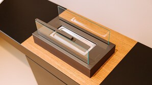 A modern, minimalist desk with a glass front organizer and a wooden surface. - Suite Queen Room 2 maggio (Monopoli)