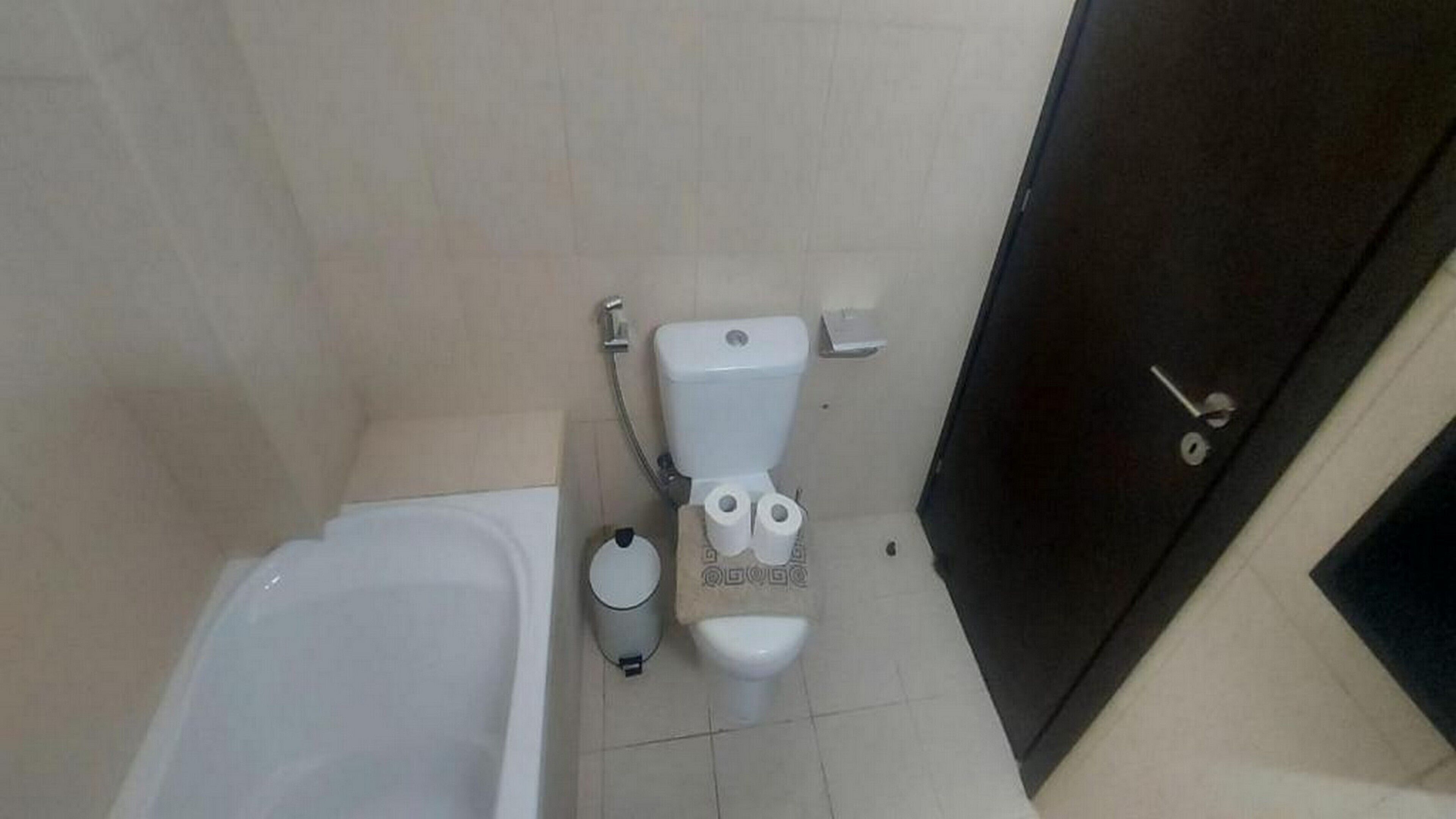 A bathroom with a bathtub, toilet, and bidet.