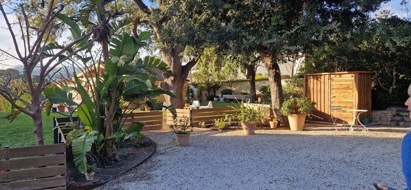 Relax in a serene garden setting with a bench and table for al fresco dining.