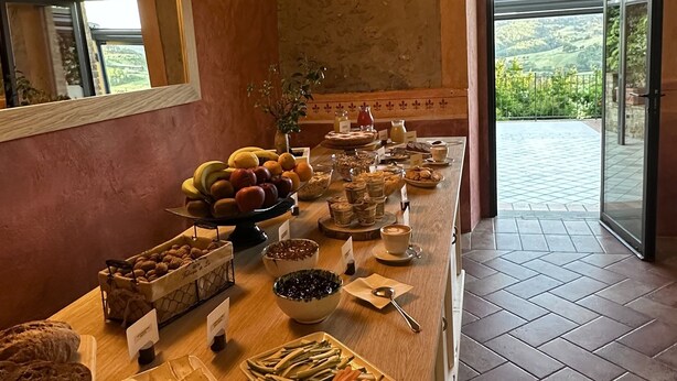 A breakfast buffet with various food items and a view of the outdoors. - Borgo Tignano (Volterra)