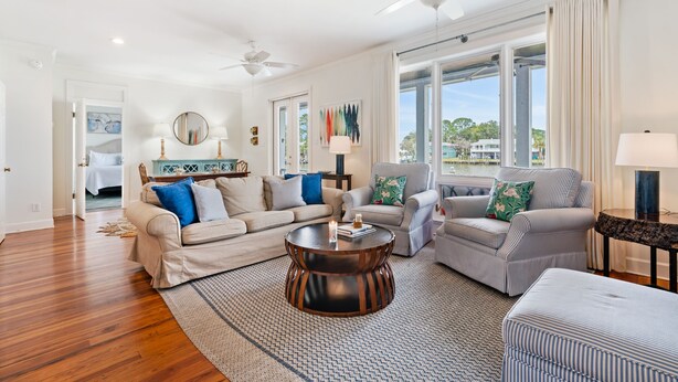 A spacious living room with a wooden floor, a round coffee table, and two sofas.