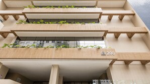 A multi-story building with a flat facade, numbered 200, featuring balconies with greenery. - Make Some Memories at This Unique Place (Praia Grande)