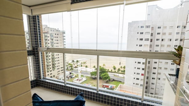 A balcony with a view of a beach and buildings. - Make Some Memories at This Unique Place (Praia Grande)