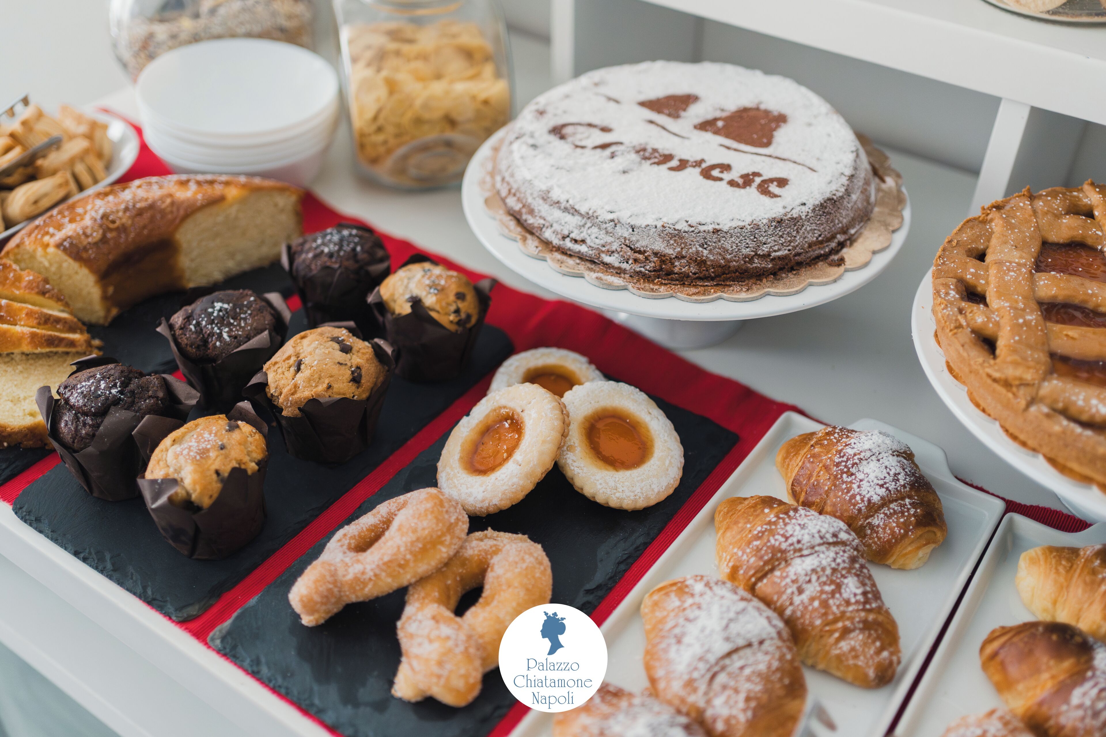 A variety of desserts including cakes, pastries, and cookies arranged on a table.