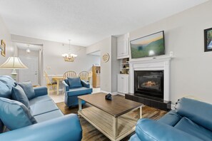 Signature Condo, 2 Bedrooms, Balcony, River View | Living room | 55-inch Smart TV with digital channels, fireplace - River View (Pigeon Forge)